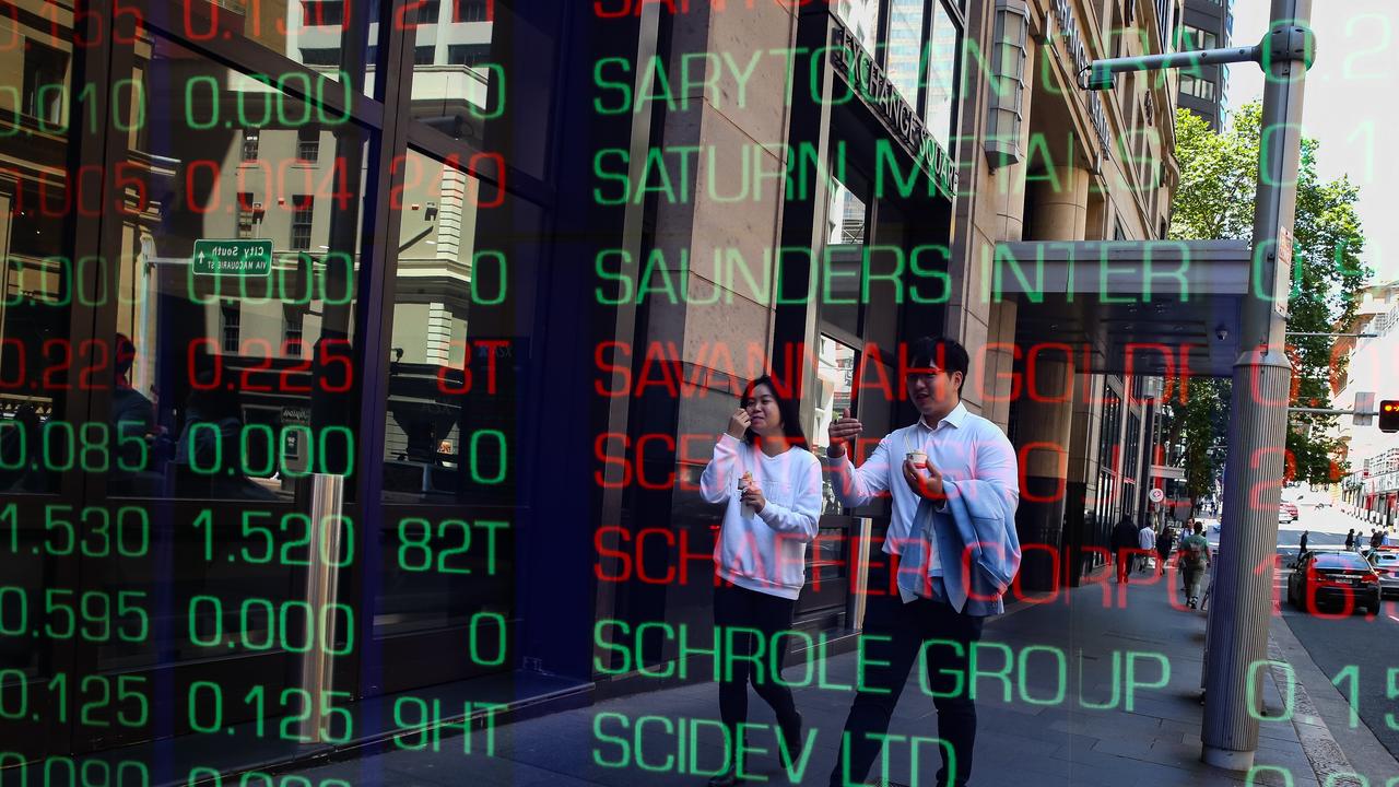 ASX edges lower amid takeover frenzy